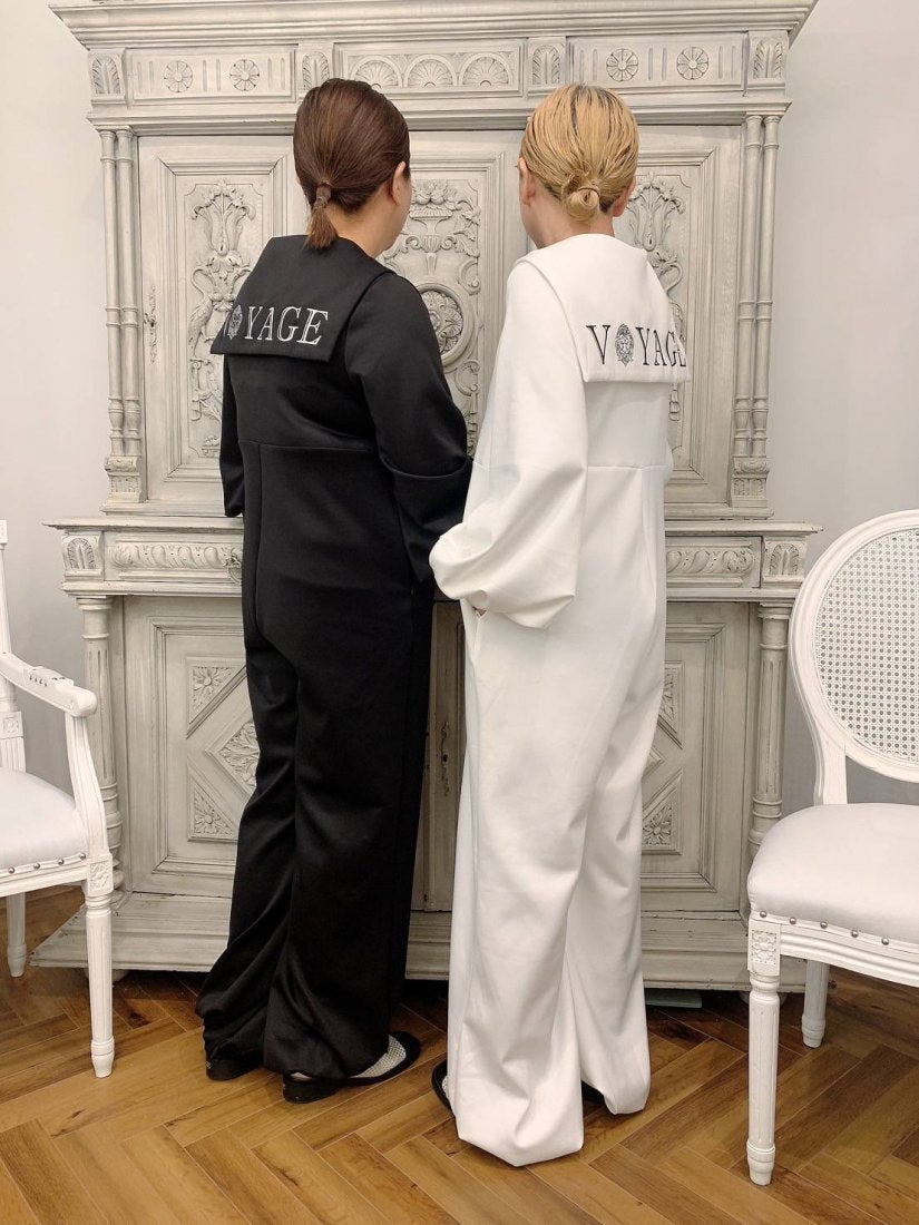 Sailor all-in-one with the "World's Best Clothing" logo